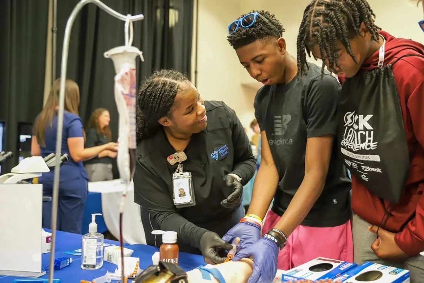 A nurse guiding students through a clinical skill at an SCK LAUNCH event