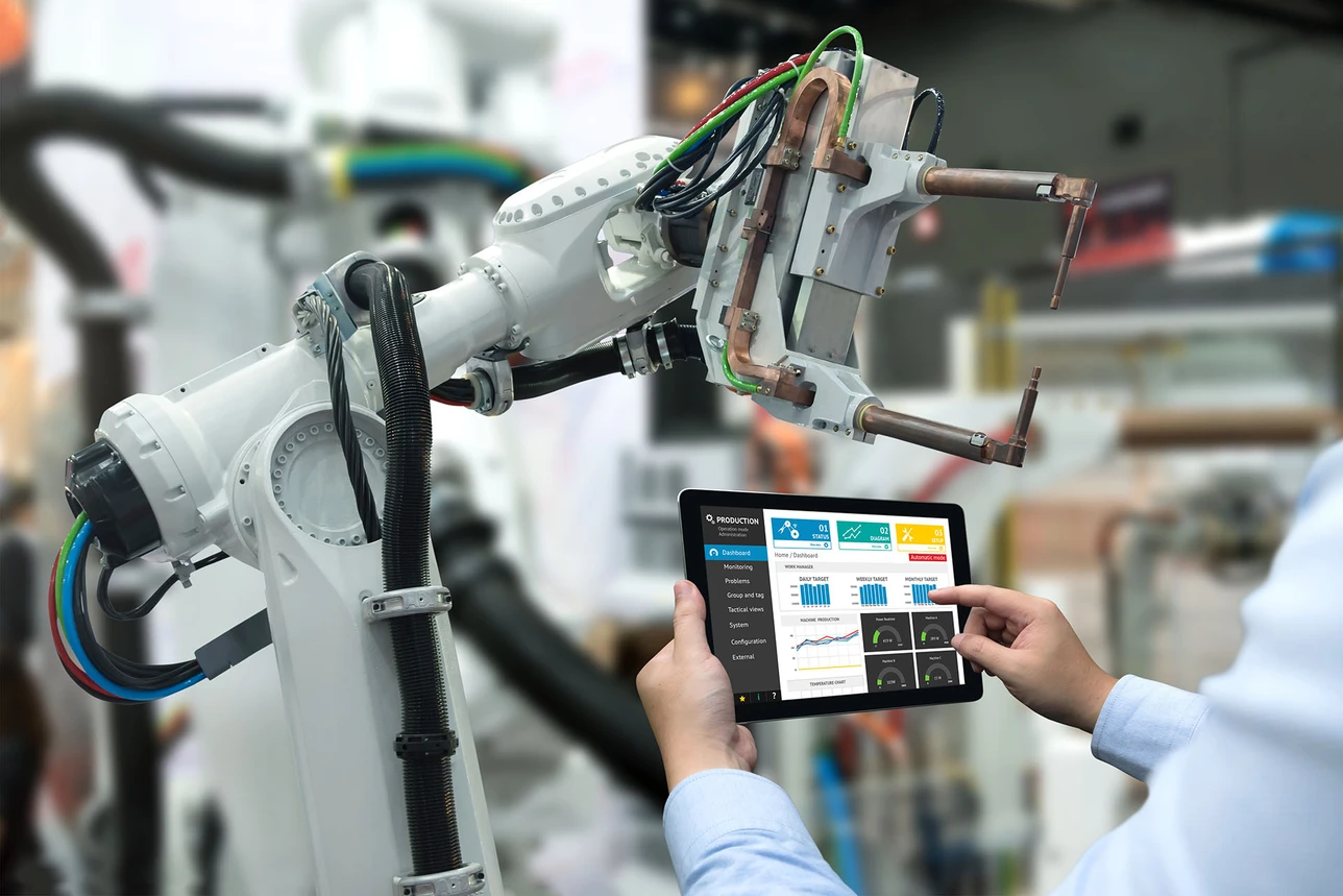 Industrial robotics operated through a tablet in a manufacturing facility