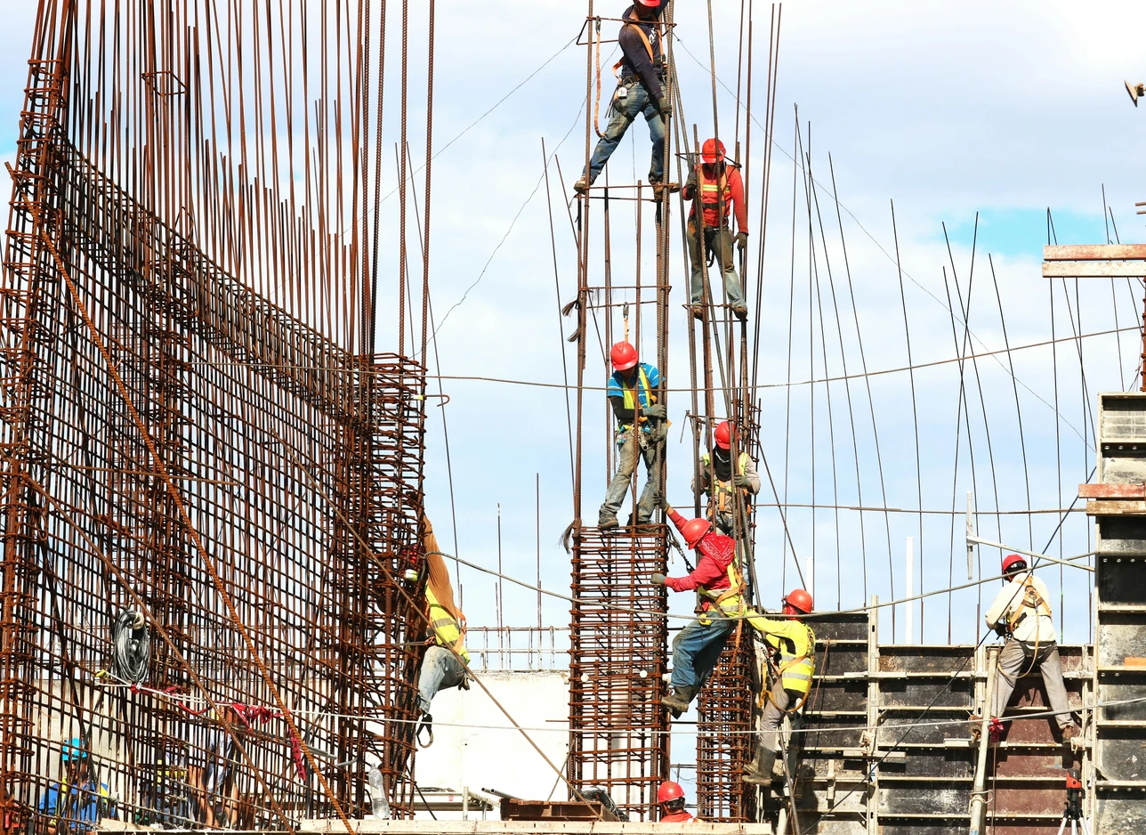 Workers tying rebar on a construction site
