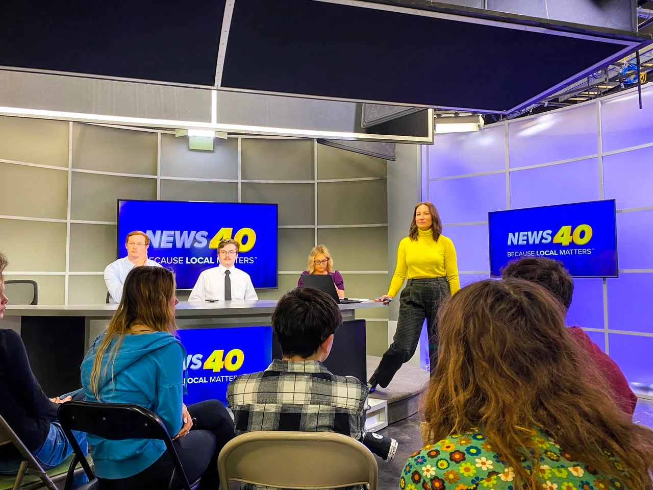 Students touring a local television newsroom